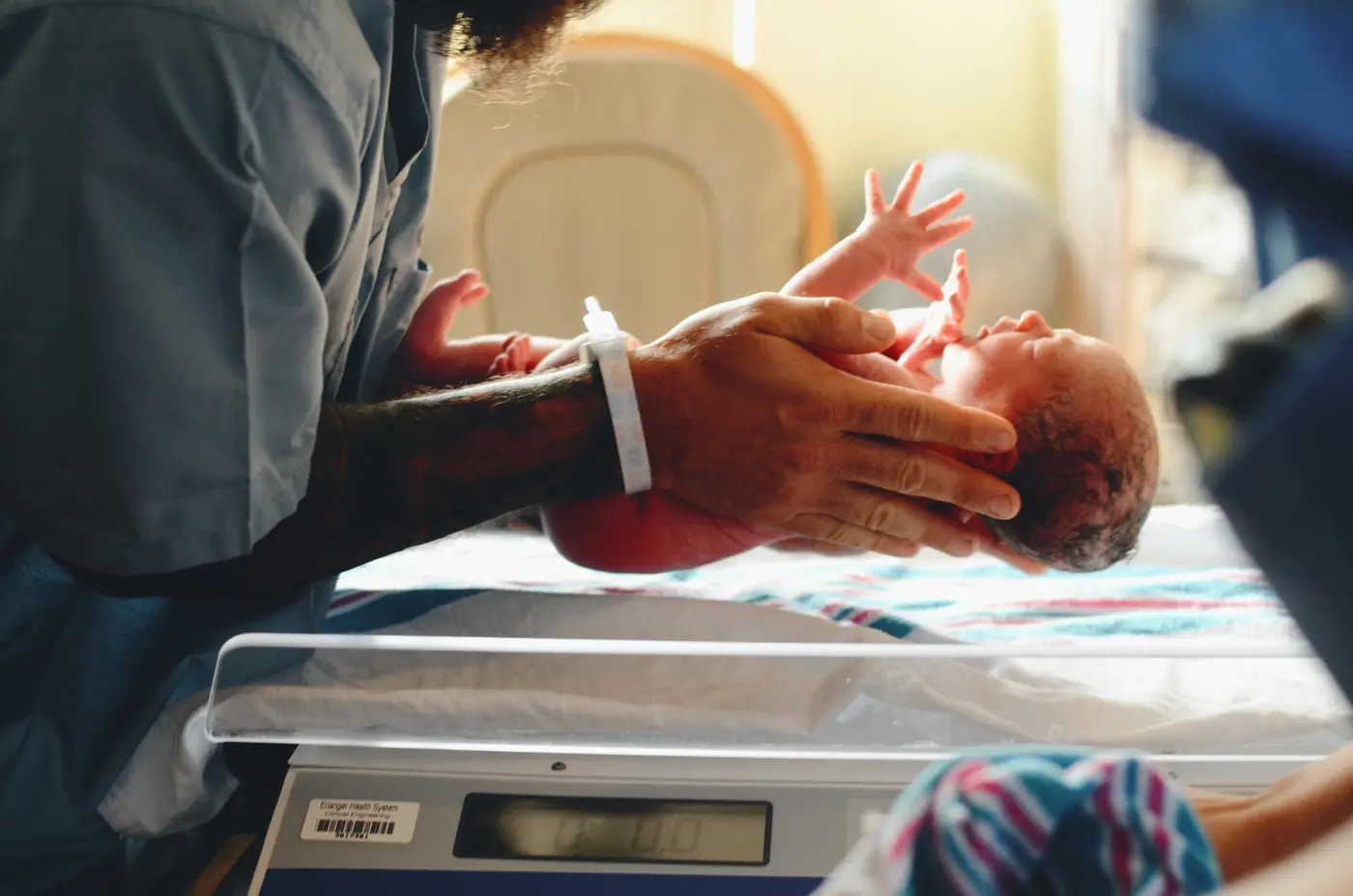 Newborn receiving attentive hospital care after birth