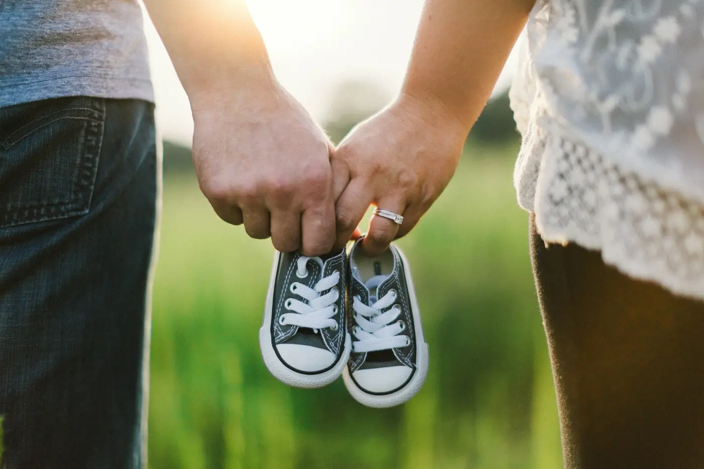 Couple preparing for parenthood with baby shoes